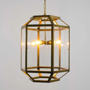 Farol de techo vintage en latón envejecido con cristal transparente y bombillas cálidas visibles.